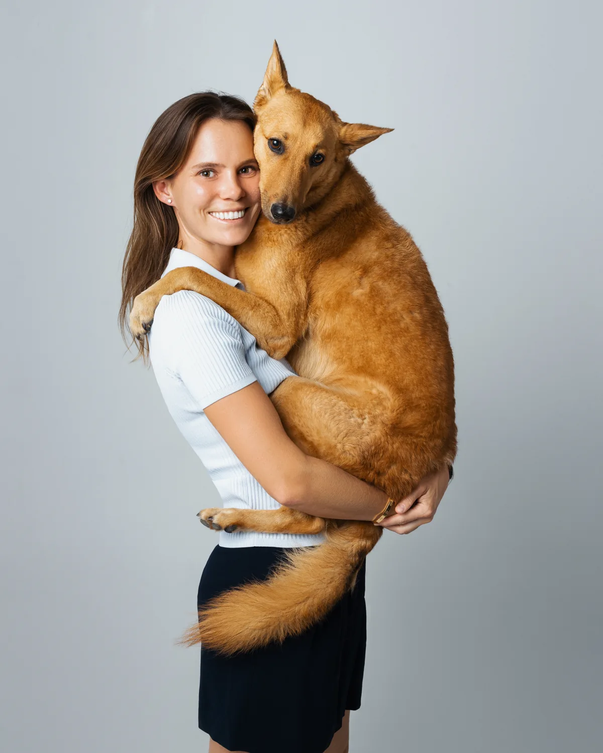 MJ Tremblay holding her rescue dog Foxxy